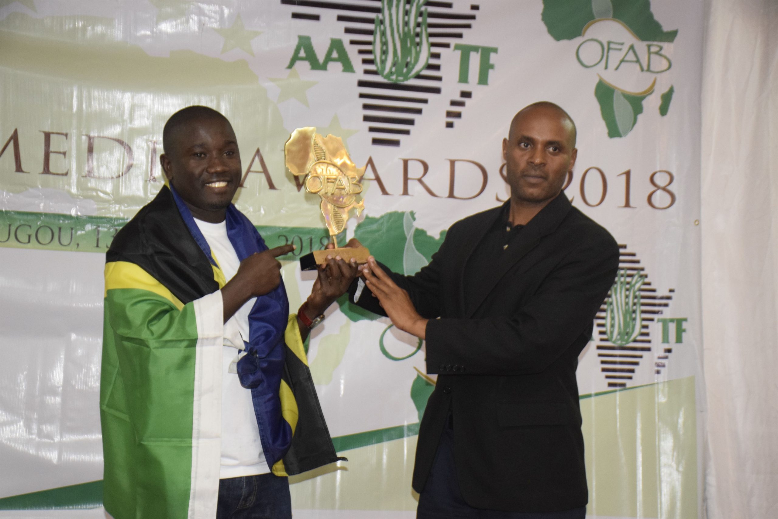 Tanzania OFAB Country cordinator Dr. Philbert Nyinondi taking a photo with winner