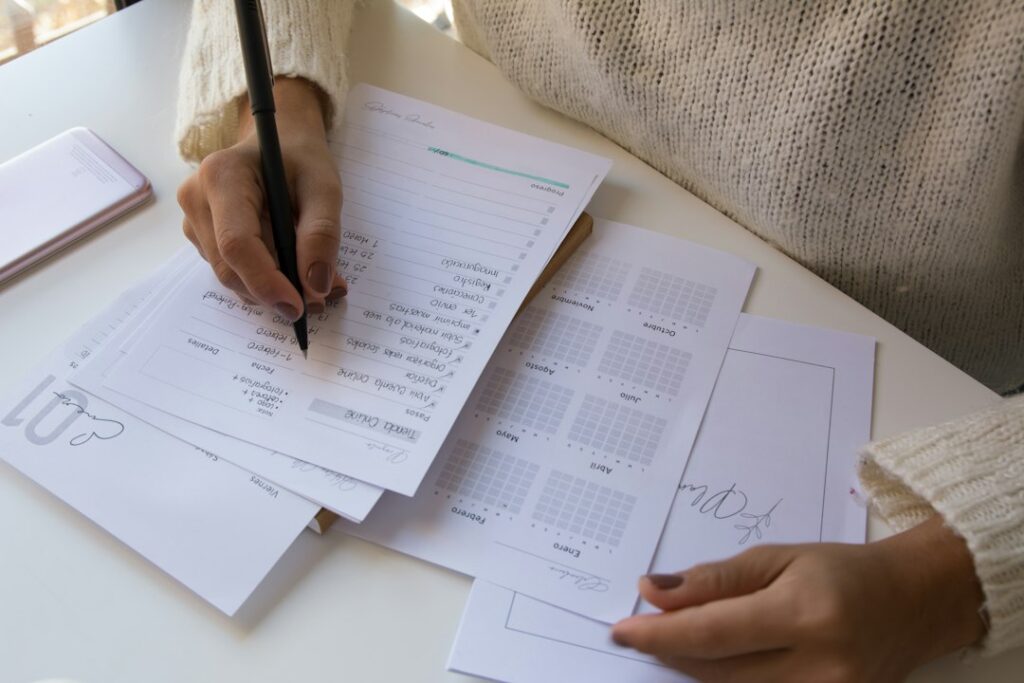 Person writing on a sheet of paper