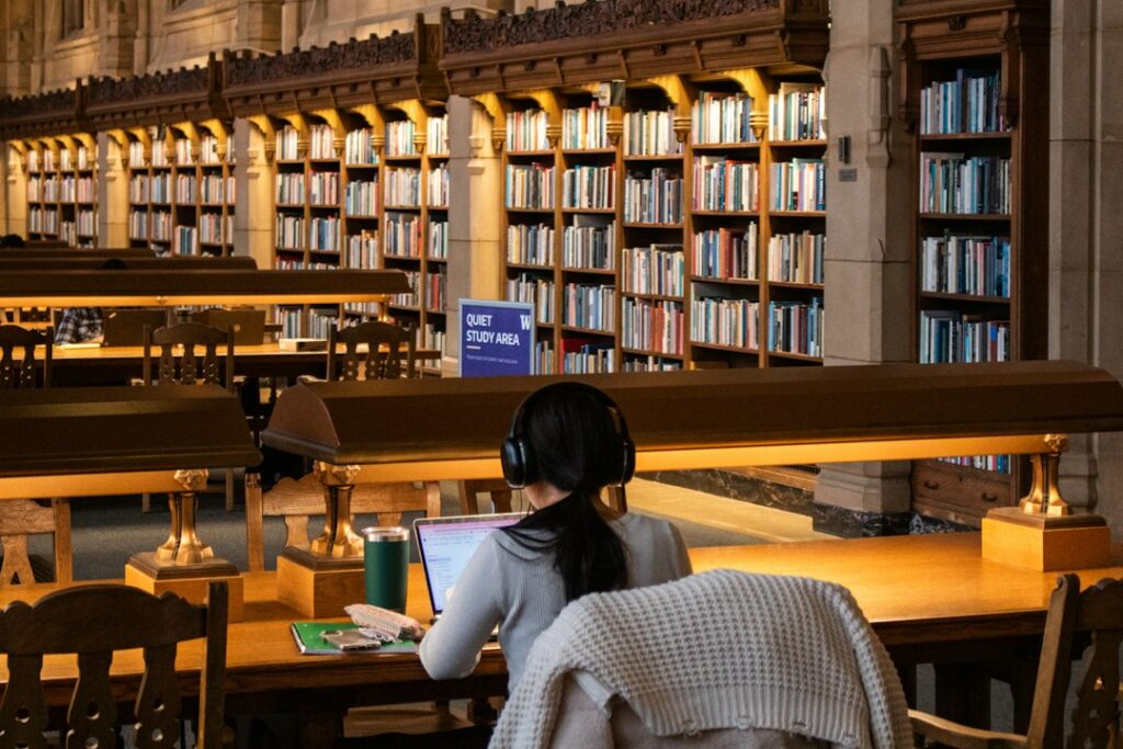 Student studying at a library table