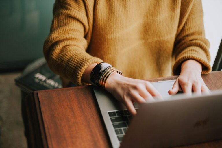 Person working with a laptop and notebook